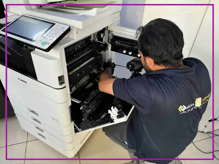 a technician is repairing a photocopy printer machine